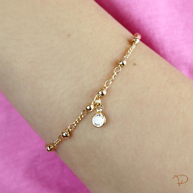 Pulseira infantil bolinhas e pingente de ponto de luz banhado a ouro 18k